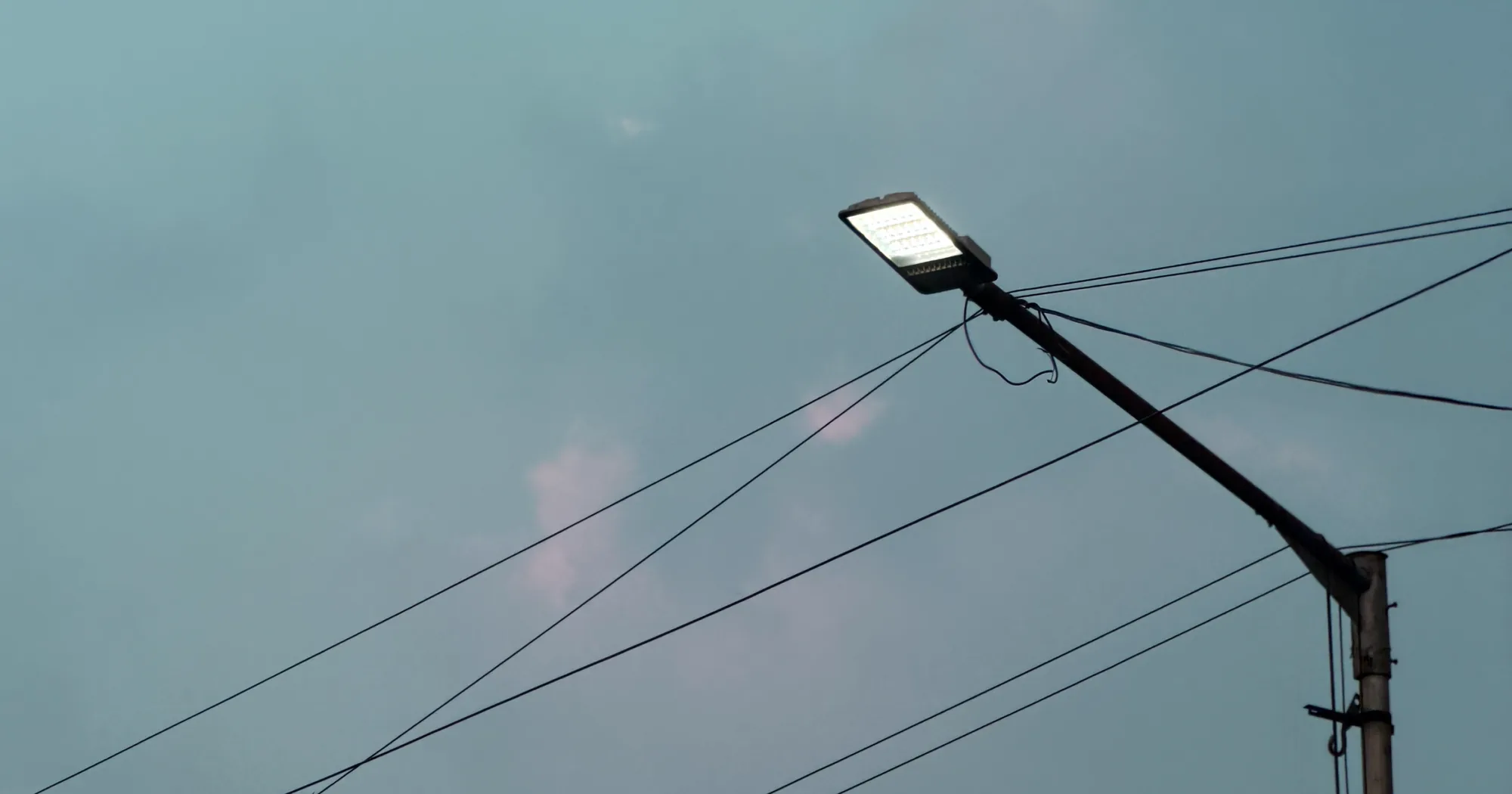 Close-up of an LED streetlight fixture showing a dense grid of individual LED emitters packed into its underside